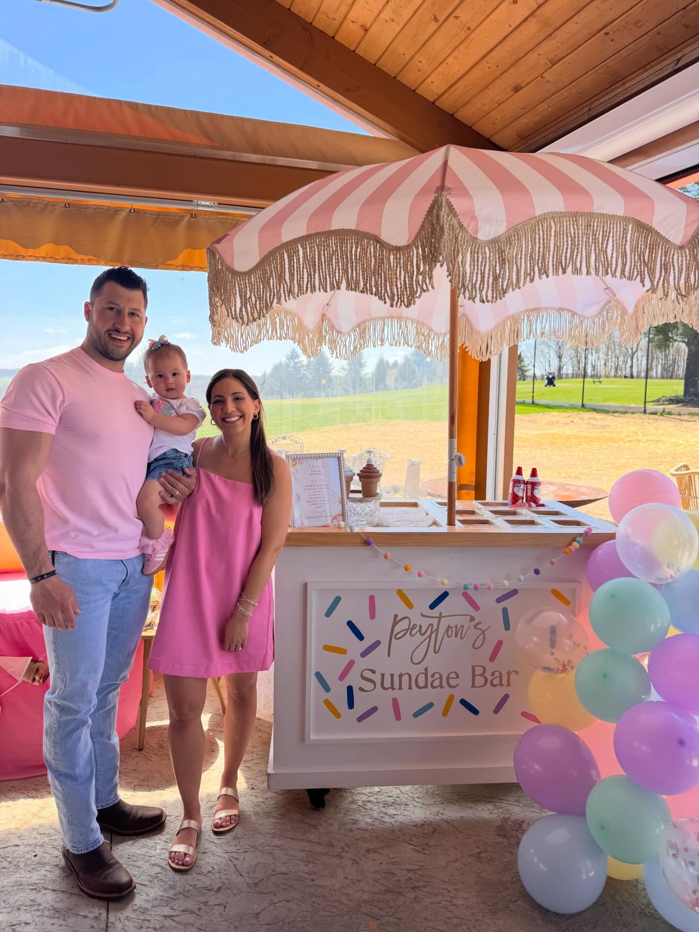 Personalized sundae bar party cart with balloons and pink striped umbrella