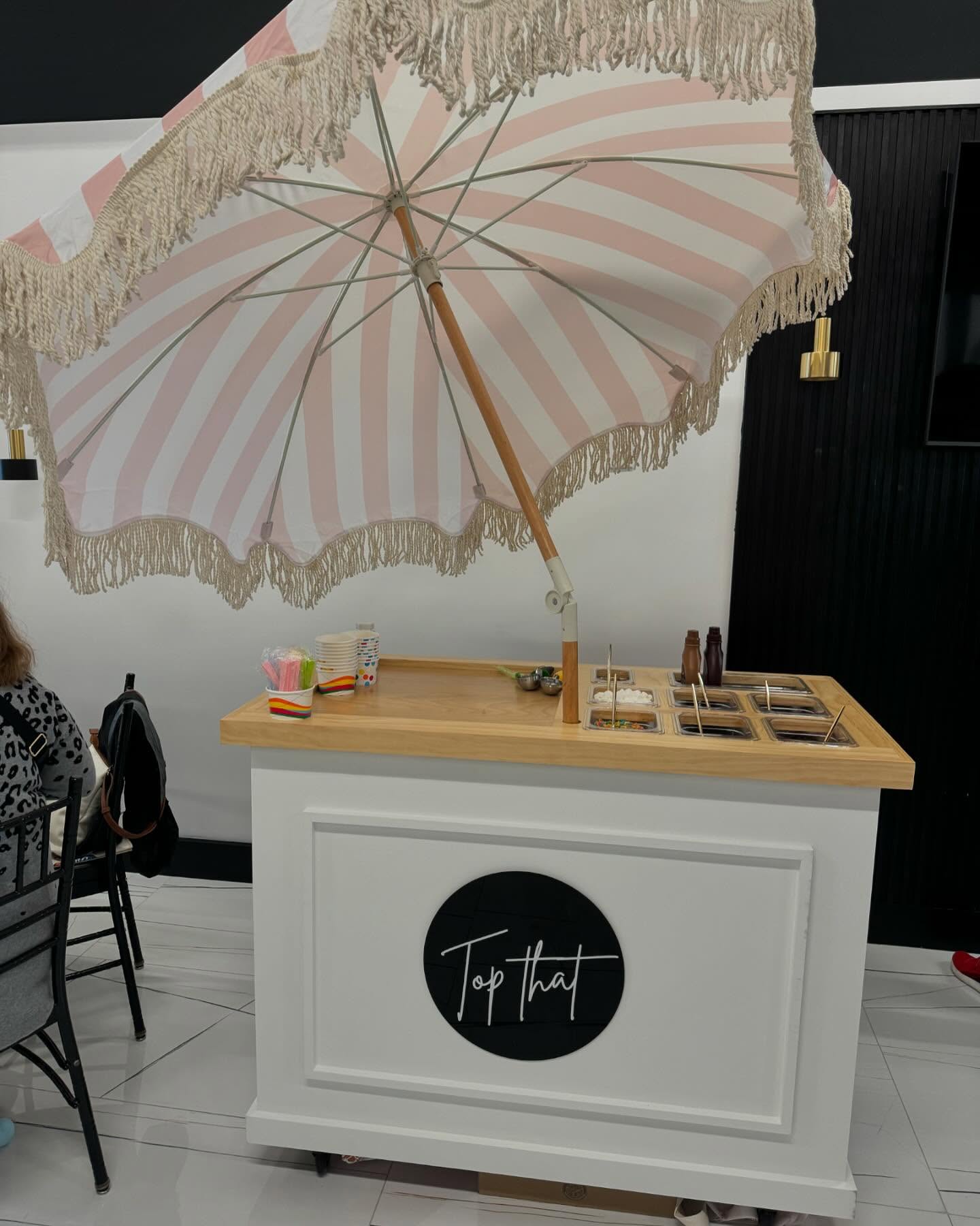 Top That Party Cart with a pink striped umbrella and custom treat station